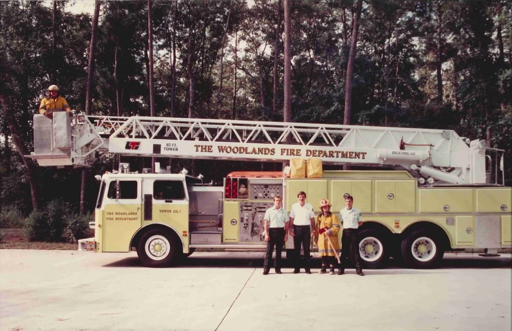 A vintage photo of a firetruck and crew