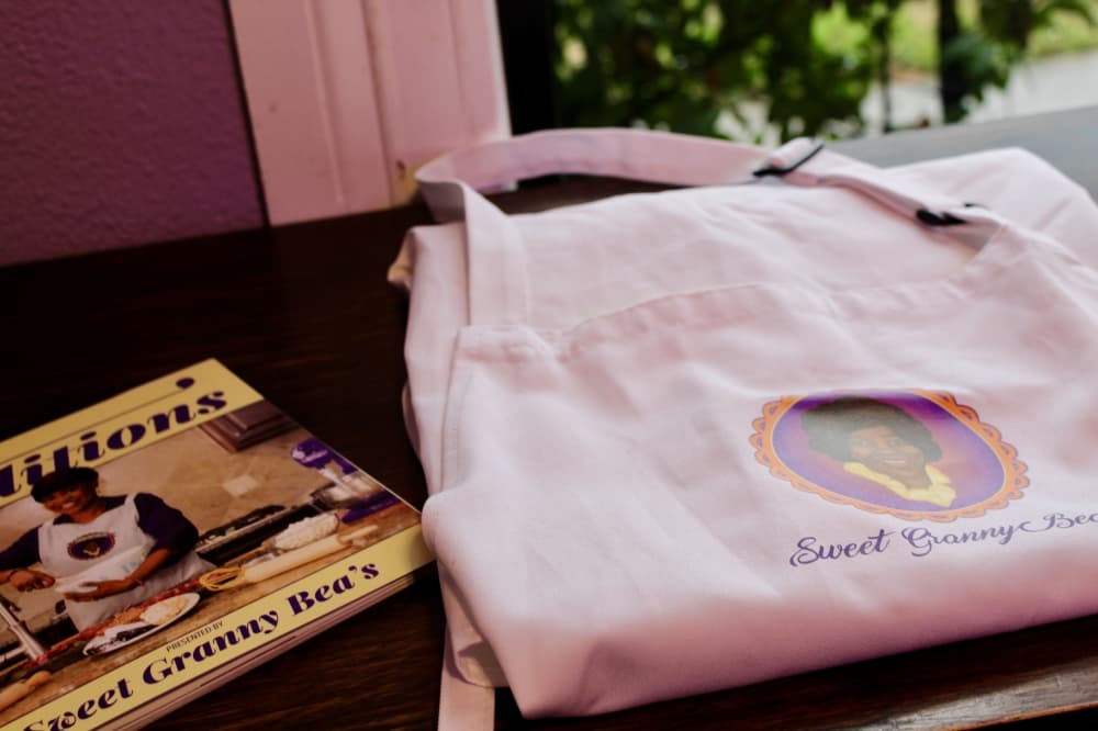 A photo of an apron and cookbook