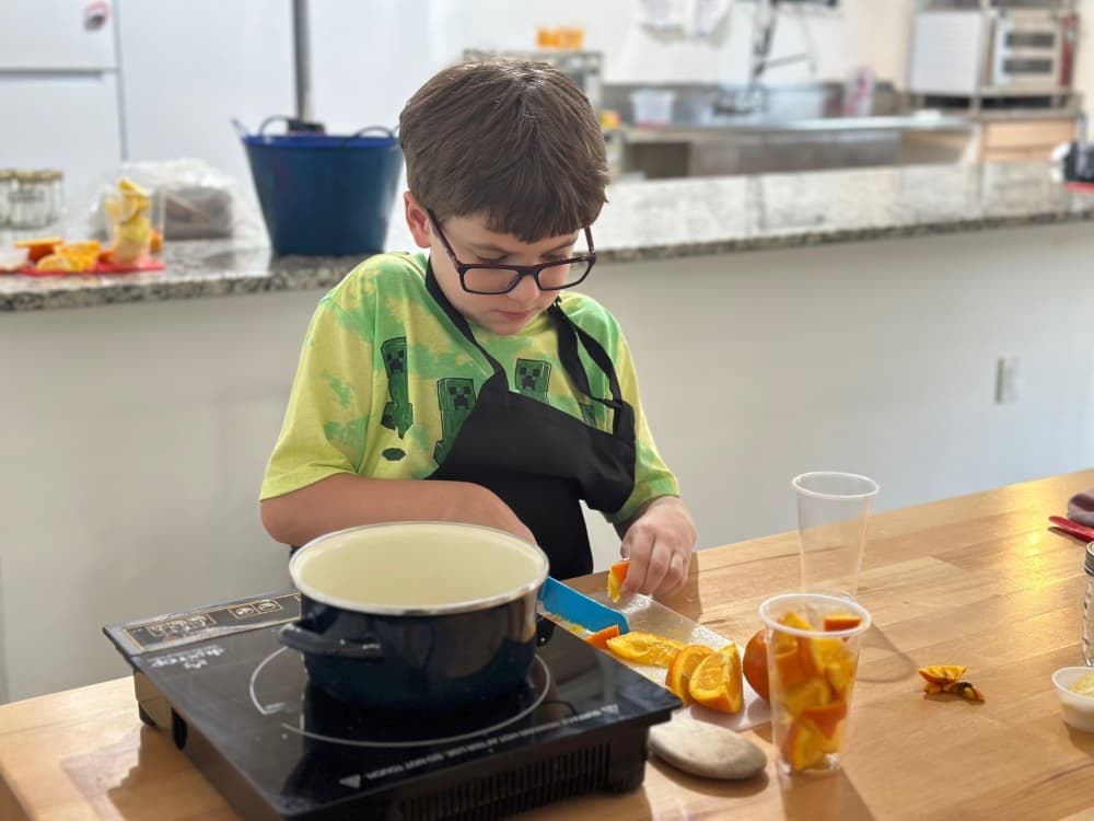 The photo shows Christopher Saunders cooking.