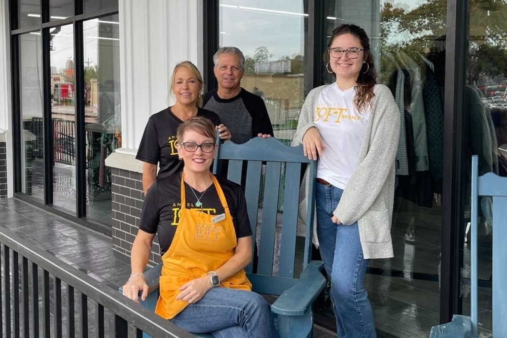 Four Angels Loft staff members posing for a picture outside the front of the store