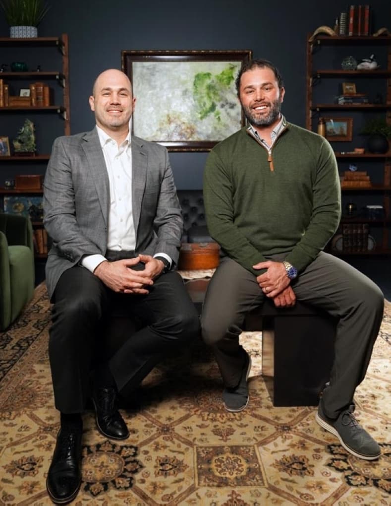 two men sit beside each other