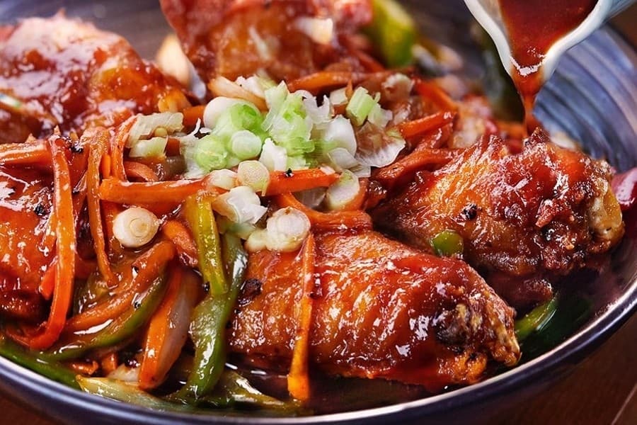 Thai Esane offerings include Bangkok wings, deep fried and topped with chili sauce and onions. (Courtesy Thai Esane)