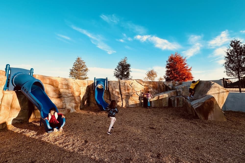 Kids playing on boulders and slides