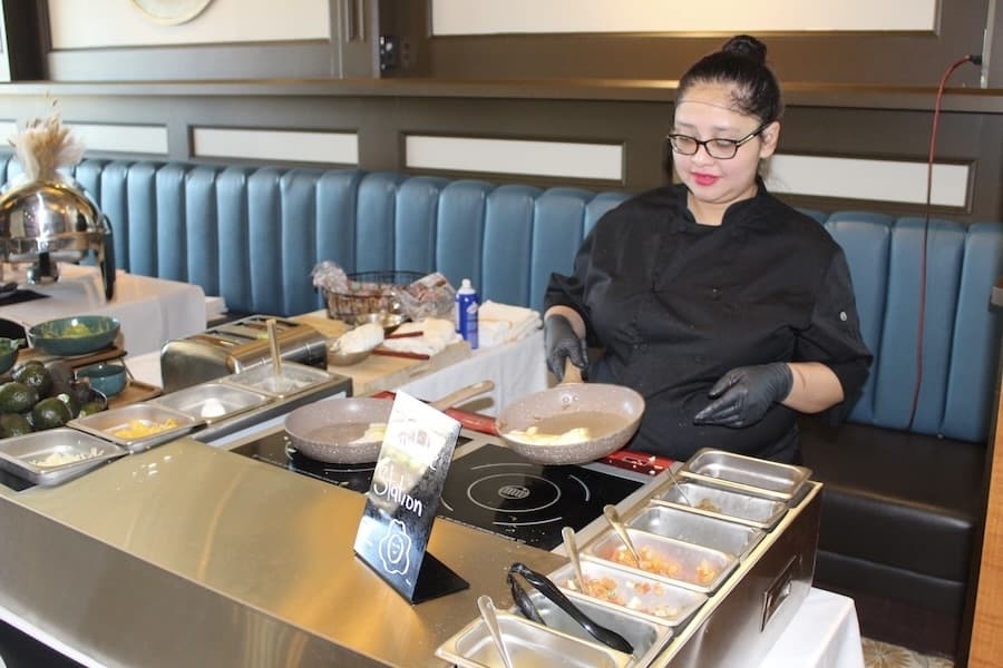 Leydi Pineda makes an omelette at Mattito's during the restaurant's Sunday buffet. (Don Munsch/Community Impact)
