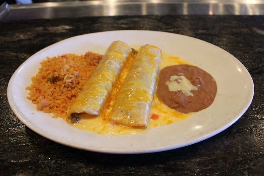 This is an enchilada plate with beef enchiladas, rice and beans. (Don Munsch/Community Impact)