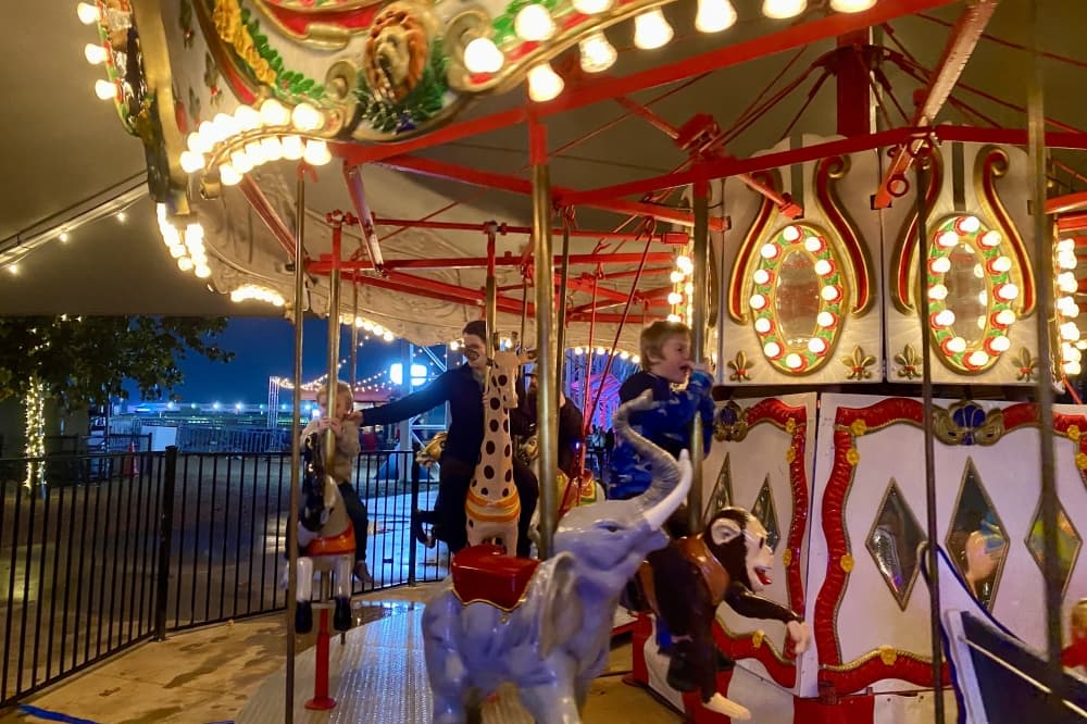 Children riding a carrossel.