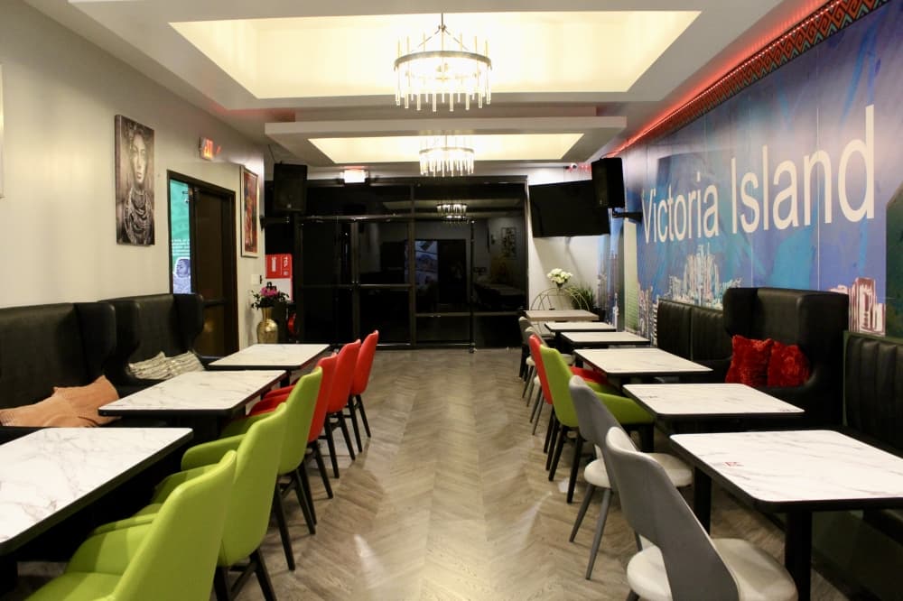 lounge with tables and green and red chairs 