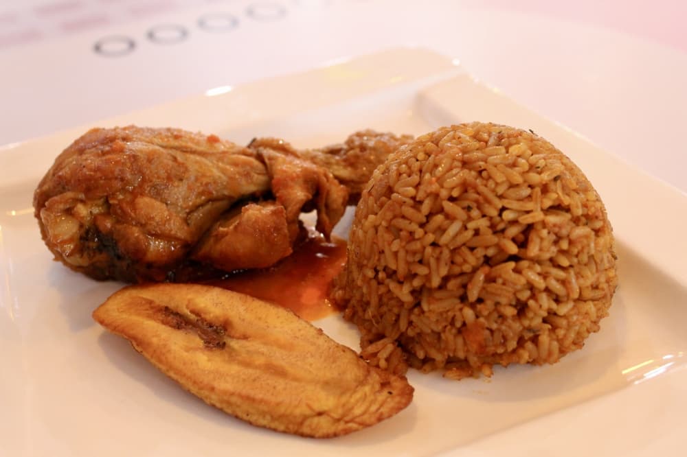 jollof rice with chicken leg and fried plantain 