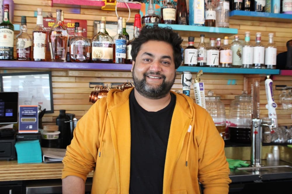 Sam Patel behind the counter. 