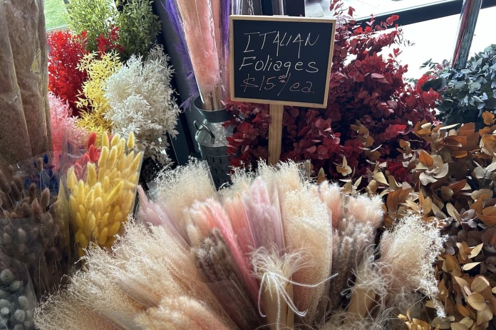 Foliages in baskets with sign that reads "Italian foliages $15 each"