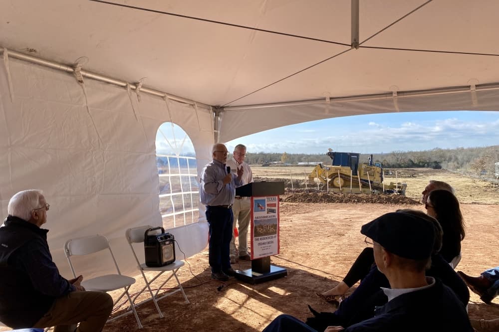 A man speaking behind a podium.