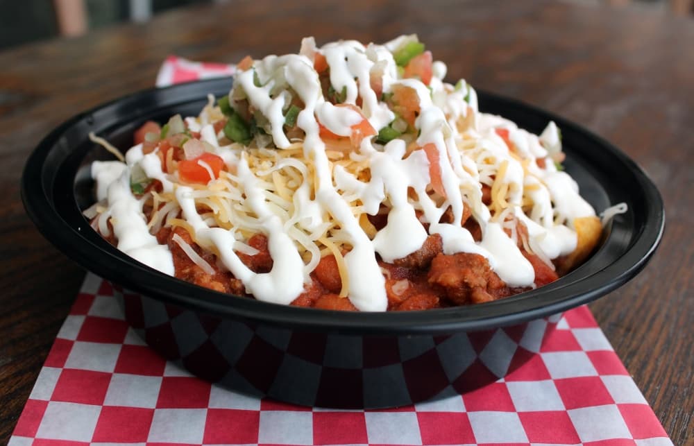 Frito Pie ($8.99) includes Fritos, homemade chili, pico, sour cream and shredded cheese. (Karen Chaney/Community Impact)
