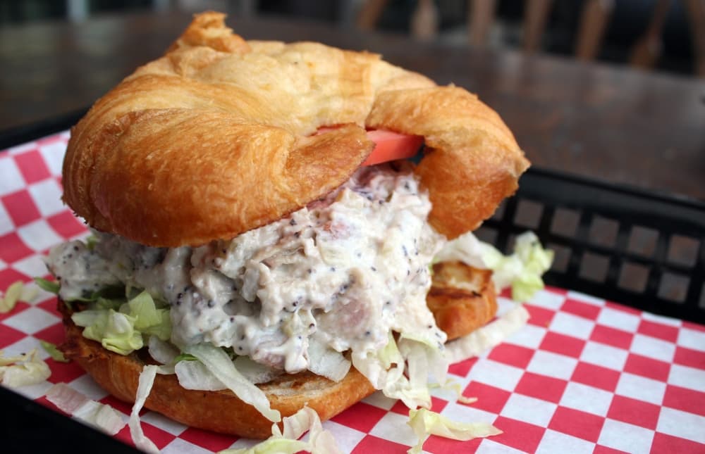 The chicken salad sandwich ($8.99) is made with fresh roasted chicken breast mixed with mayo, celery, cranberries, pecans, poppy seeds, lettuce and tomato.(Karen Chaney/Community Impact)
