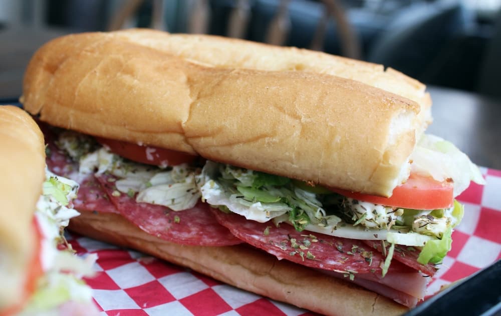 The Italian Hero Hoagie (12-inch $16.99, 6-inch $10.49) includes ham, salami, mortadella, provolone cheese, lettuce, tomato, onion, pepperoncini, mayo, vinegar, oil and Italian seasoning. (Karen Chaney/Community Impact)