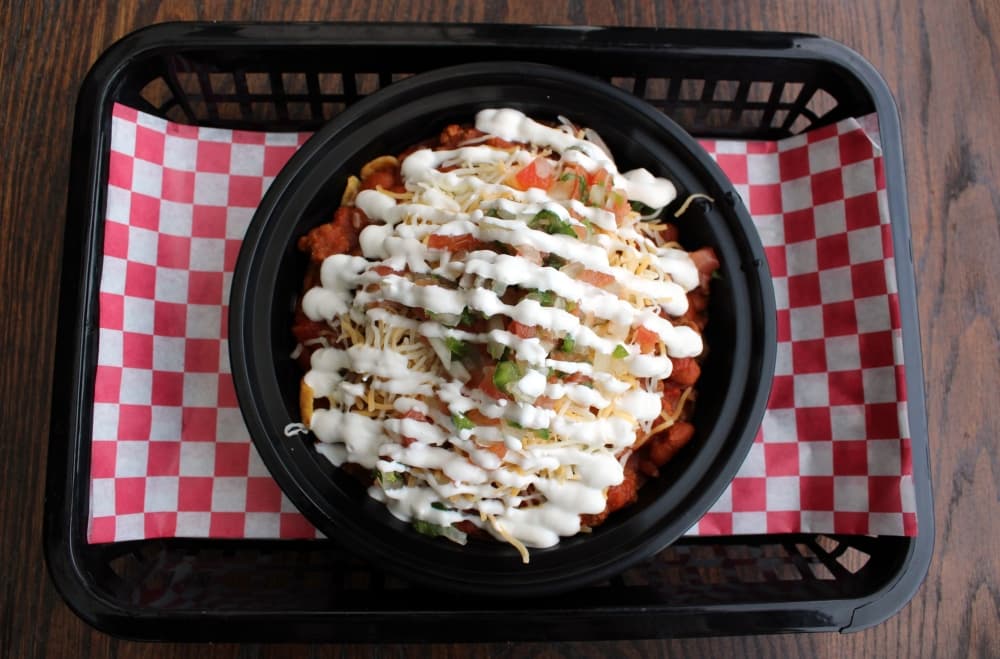 Frito Pie ($8.99) includes Fritos, homemade chili, pico, sour cream and shredded cheese. (Karen Chaney/Community Impact)