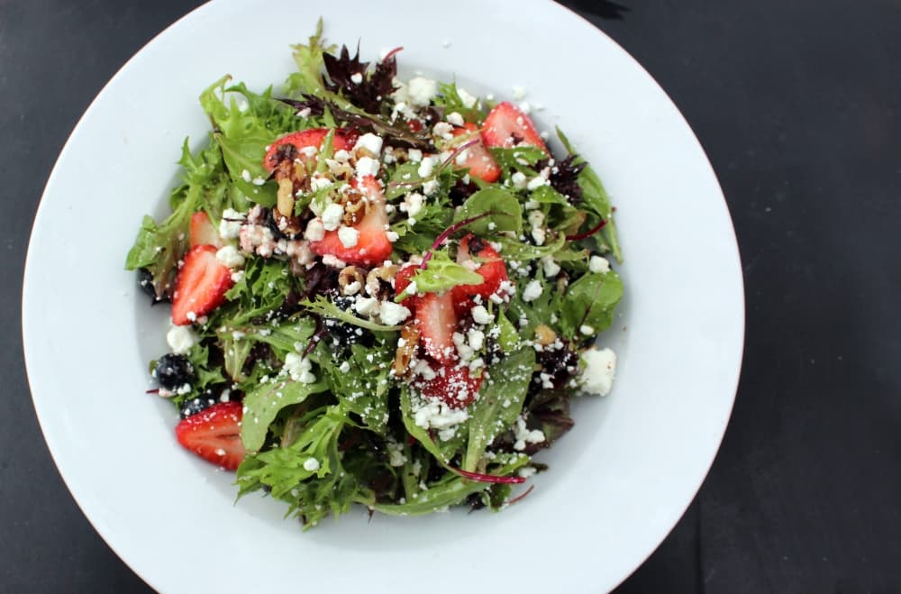 Mixed green salad featuring fruit