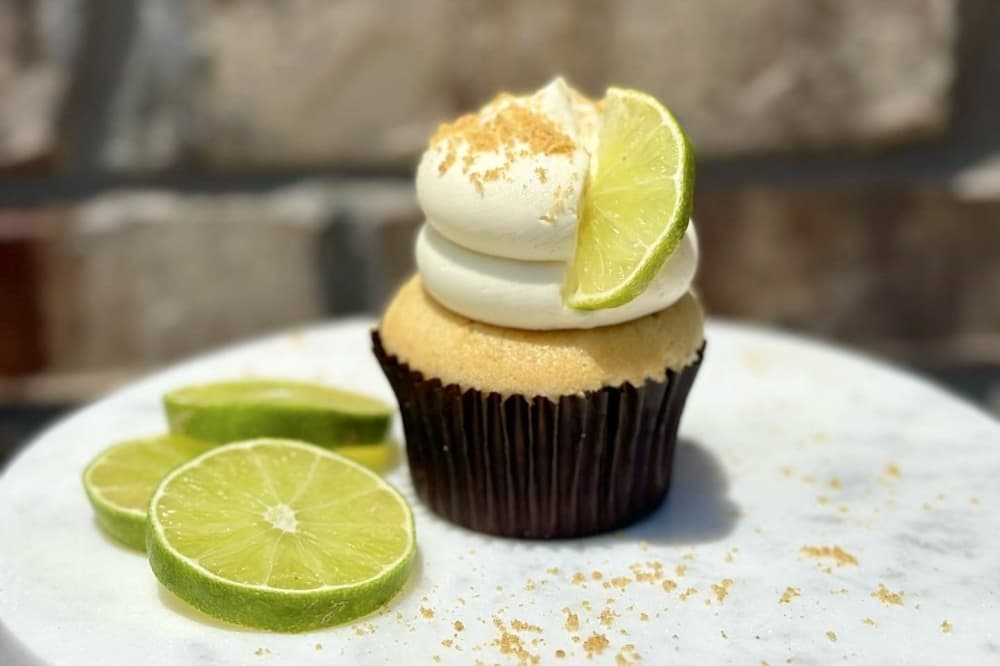 a cupcake with frosting a lime wedge