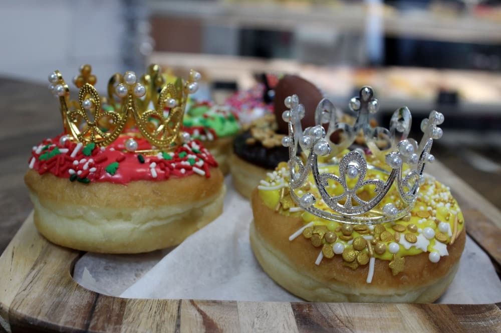 Donuts decorated with sprinkles and crowns