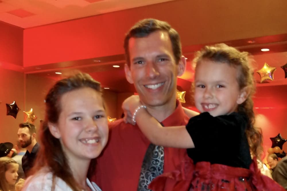 Father and daughters at dance