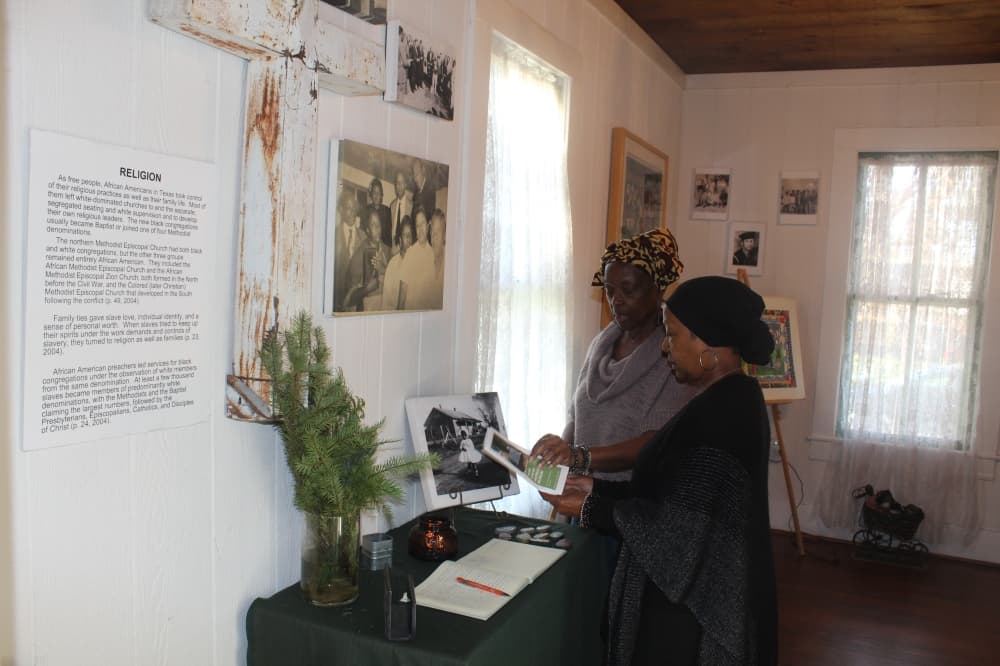 Dollie and Toni Thomas look over documents at the Plano African American Museum