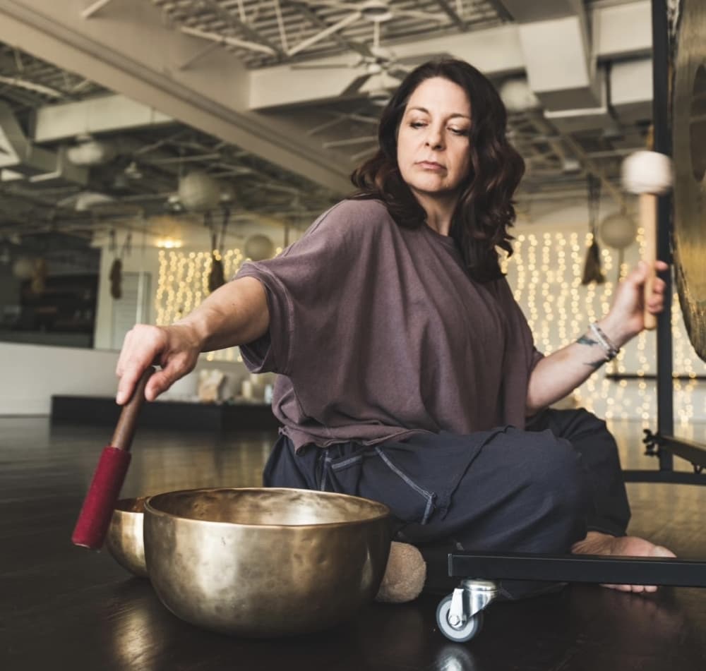 Woman playing metal instruments. 