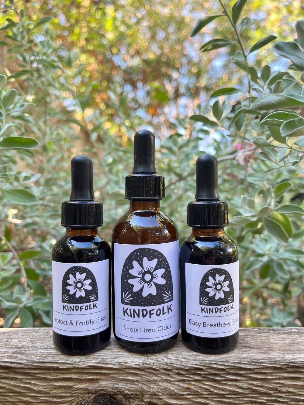 3 liquid supplements in dark bottles with droppers
