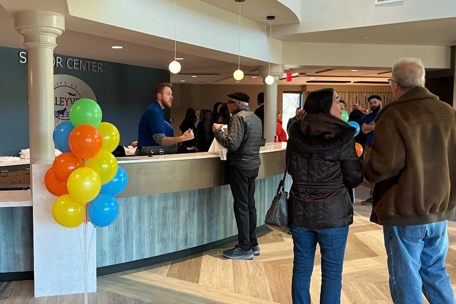 people checking in at front desk 