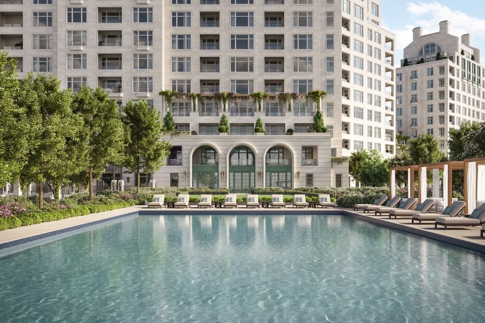 A poolside view of the exterior of a residential complex
