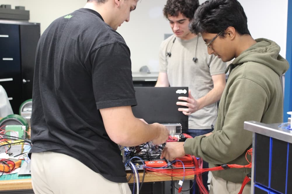 team of employees working on wiring 