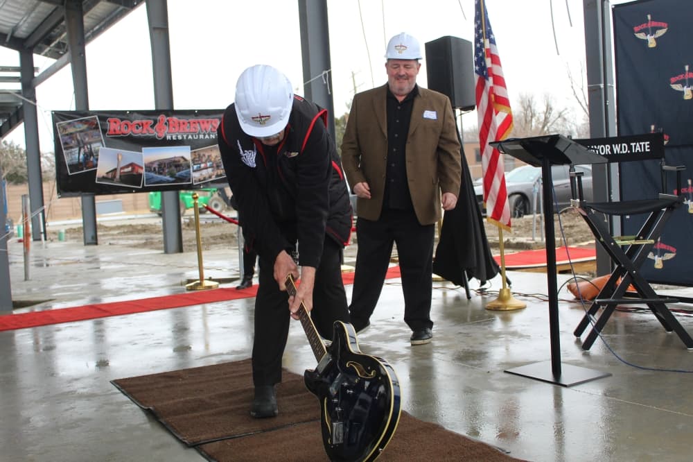 the mayor smashes the guitar on the ground