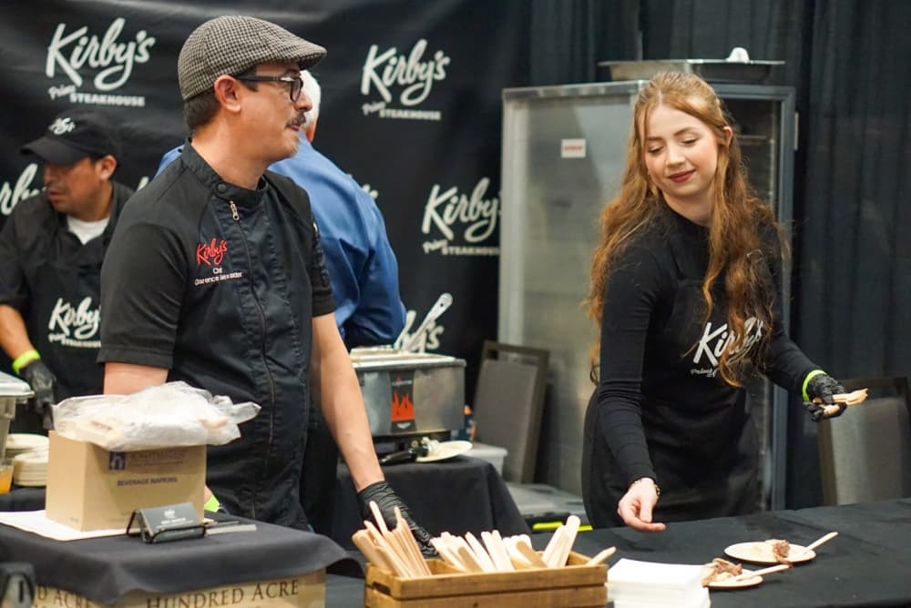 Two people prepare food samples