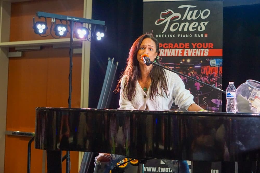 A woman performs at a piano