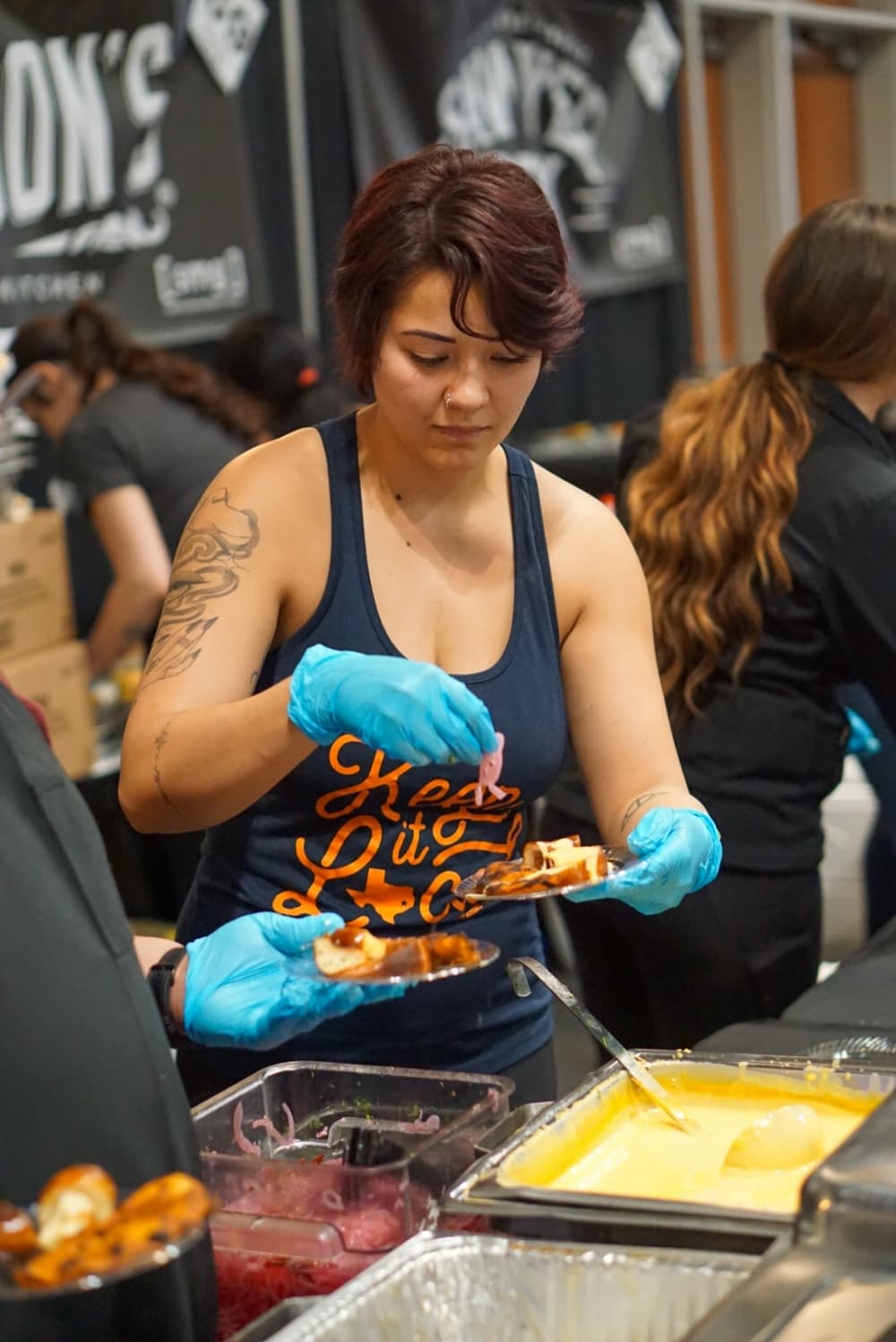 A woman prepares food items on a tray
