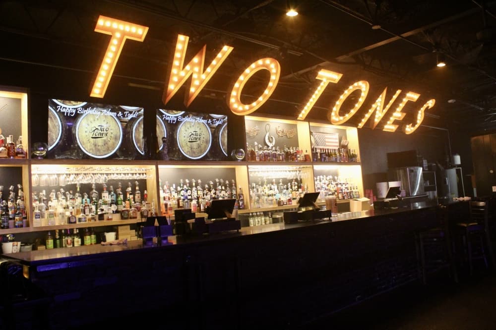 A bar lit by a sign