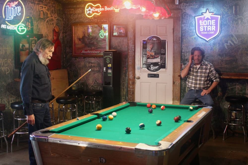two people playing pool