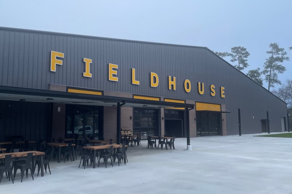 The photo shows the exterior of Community Fieldhouse. 