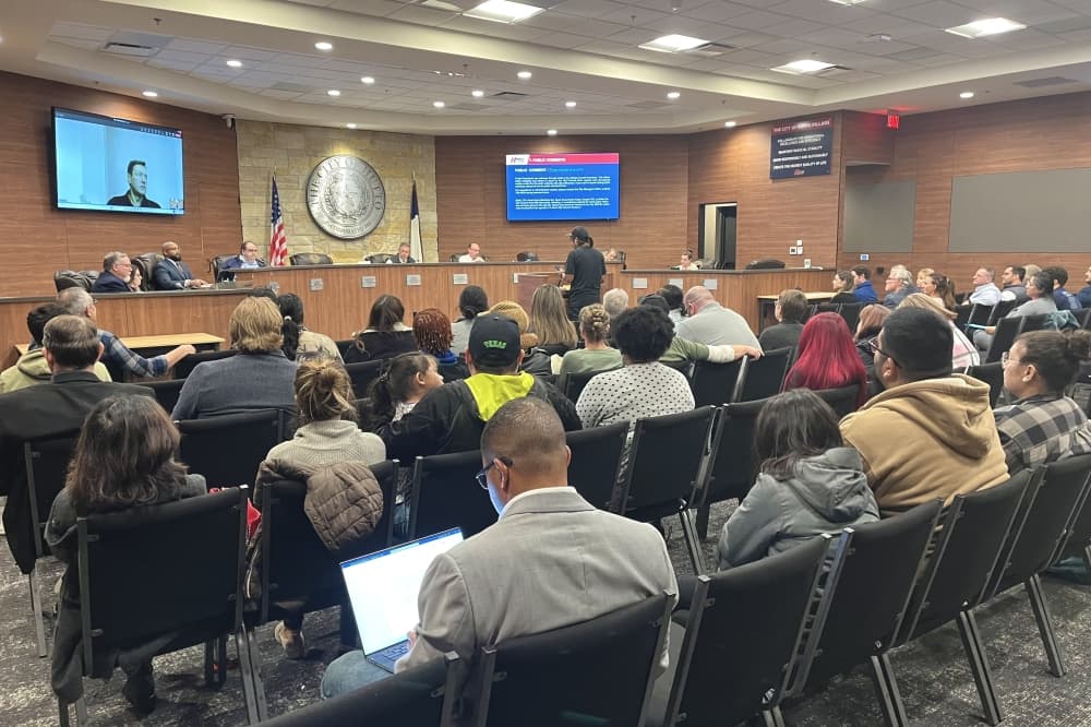 A large crowd of people sit waiting to speak during public comment at a Hutto City Council meeting. 