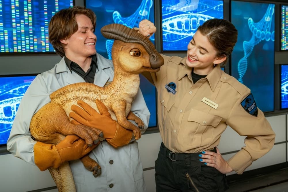 employees look at baby dinosaur