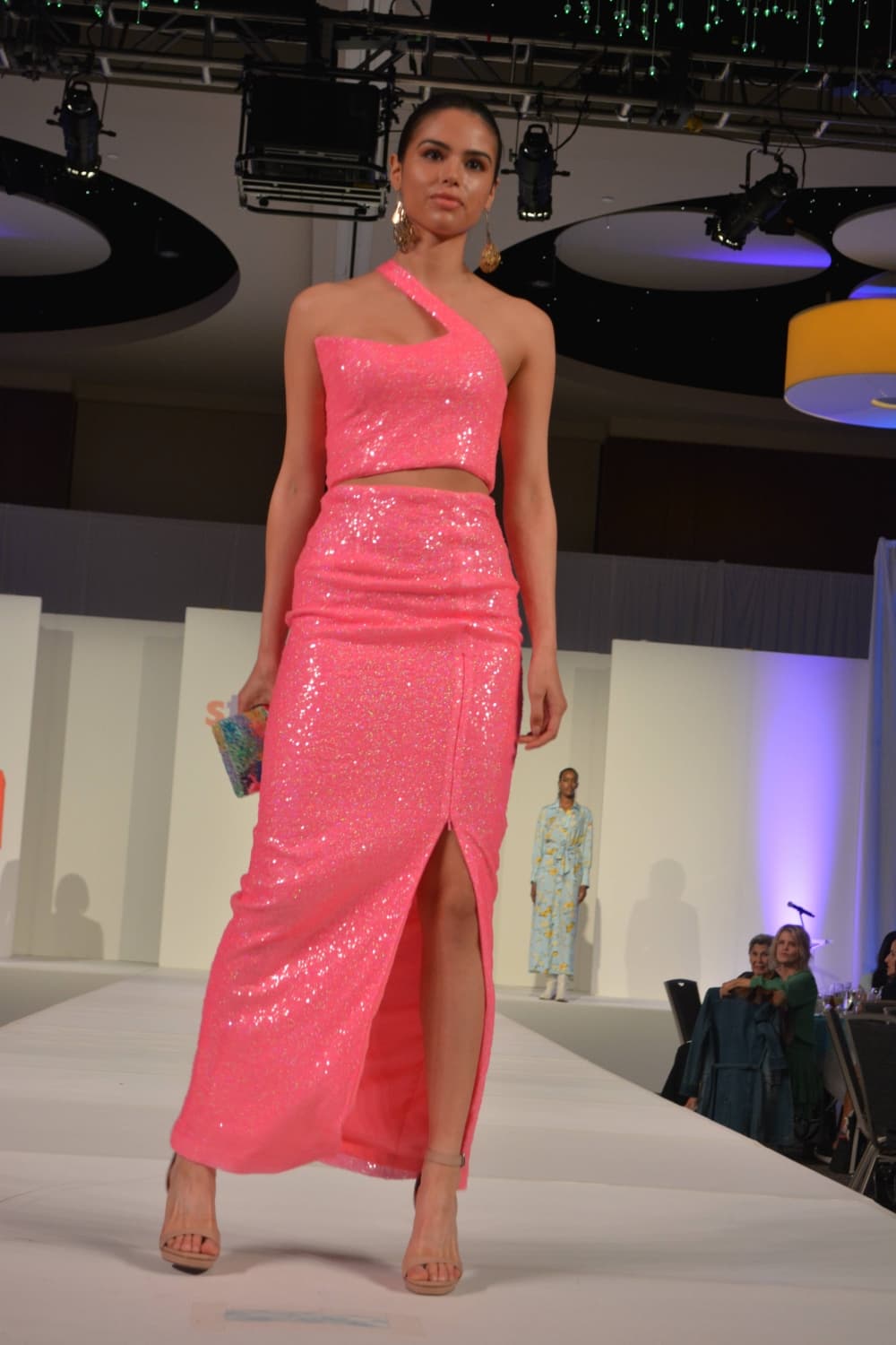 Woman wearing pink dress on a stage.