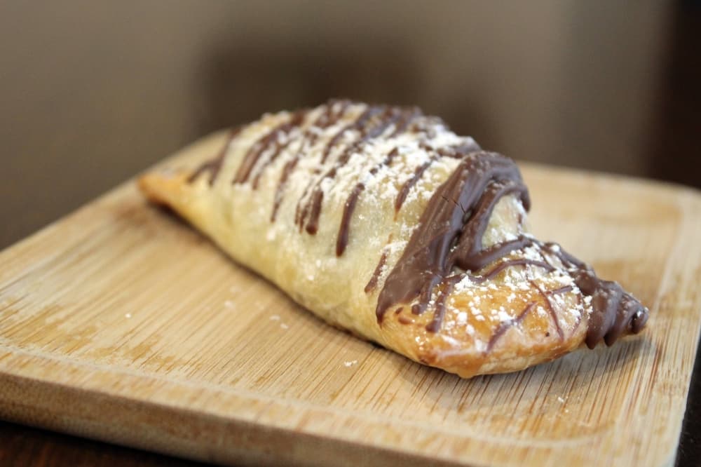 Sweet empanada on a wooden tray