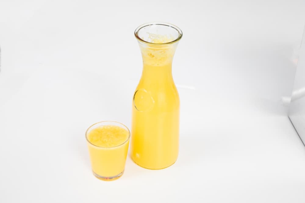 A carafe and a glass hold orange mimosa. (Courtesy Phoebe's Diner)