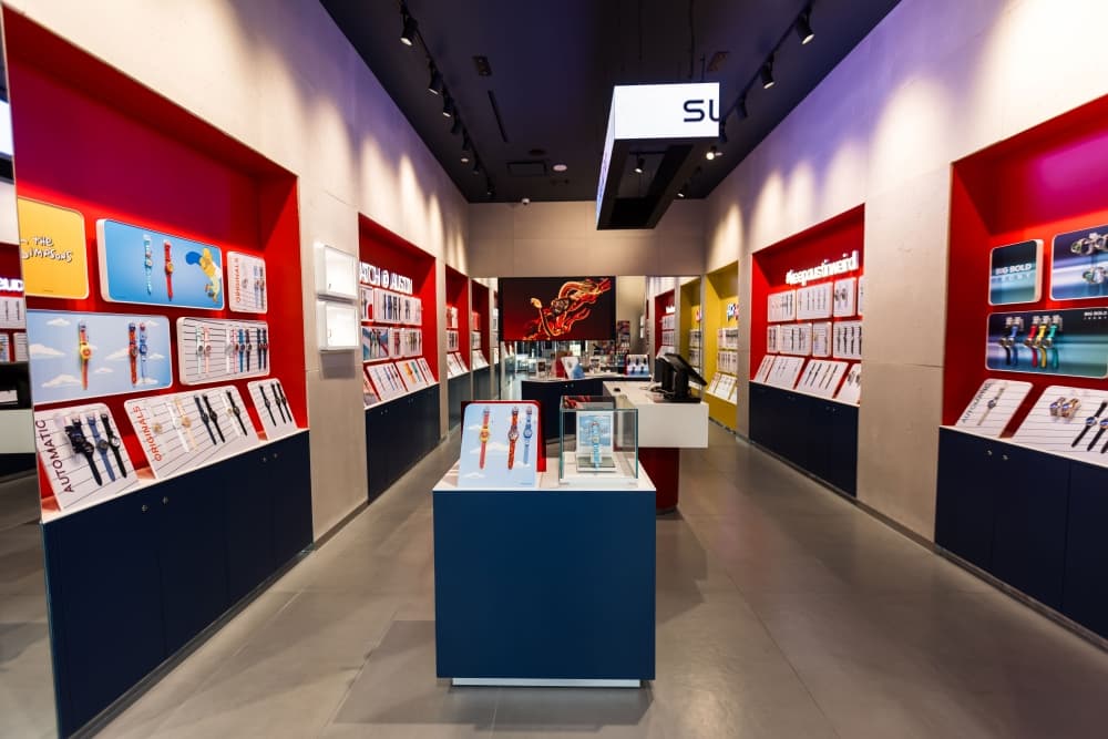 The interior of the store is shown with white walls and red accents.