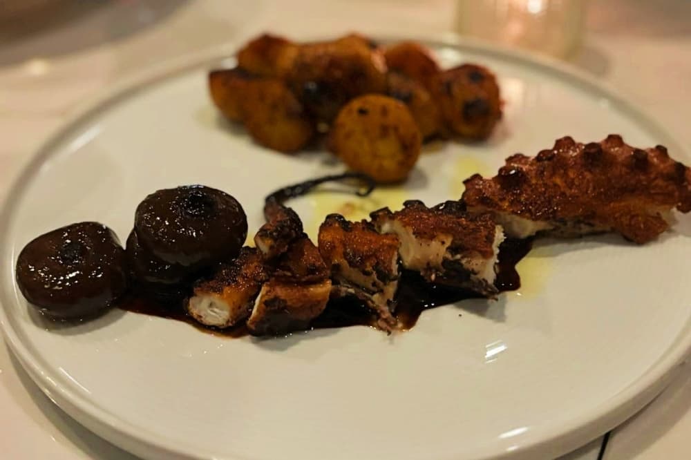 One of the appetizers on the menu at Teatro Bistro and Cocktail Lounge is charred Spanish octopus, which is braised and then grilled. It is coupled with brava roasted baby potatoes, balsamic glazed cipollini onions and pesto sauce. (Cody Thorn/Community Impact)