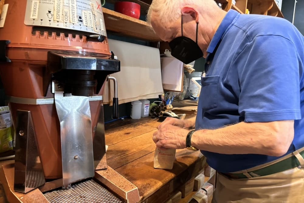 Owner Jamie Anderson seals a bag of coffee beans at his shop.