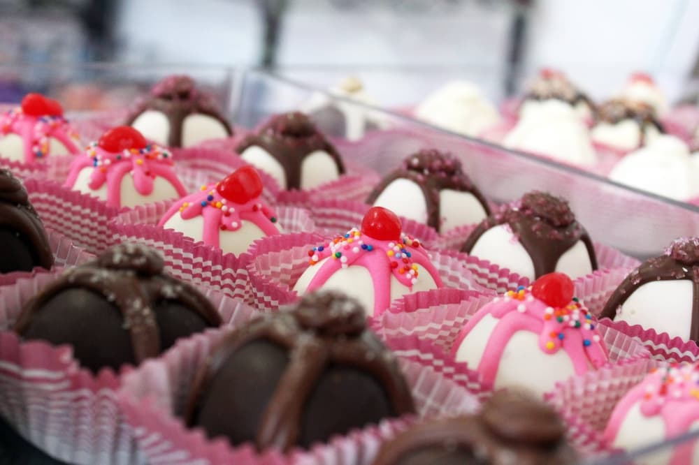 A variety of truffles in a display case. 