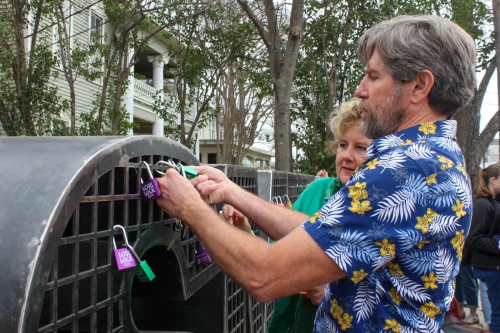 Shawn Dupont places a lock on the SMTX Love Lock installation