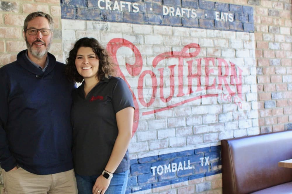 Father and daughter duo Autumn and Mark Zientek in front of their business logo