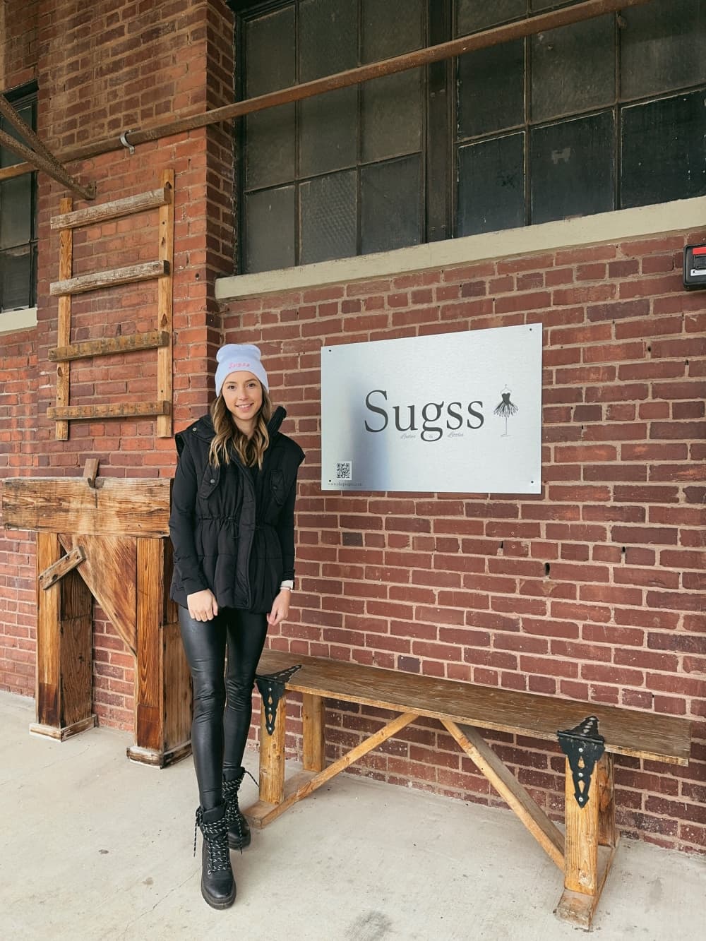 Owner Sugar Ahrens with the Sugss sign