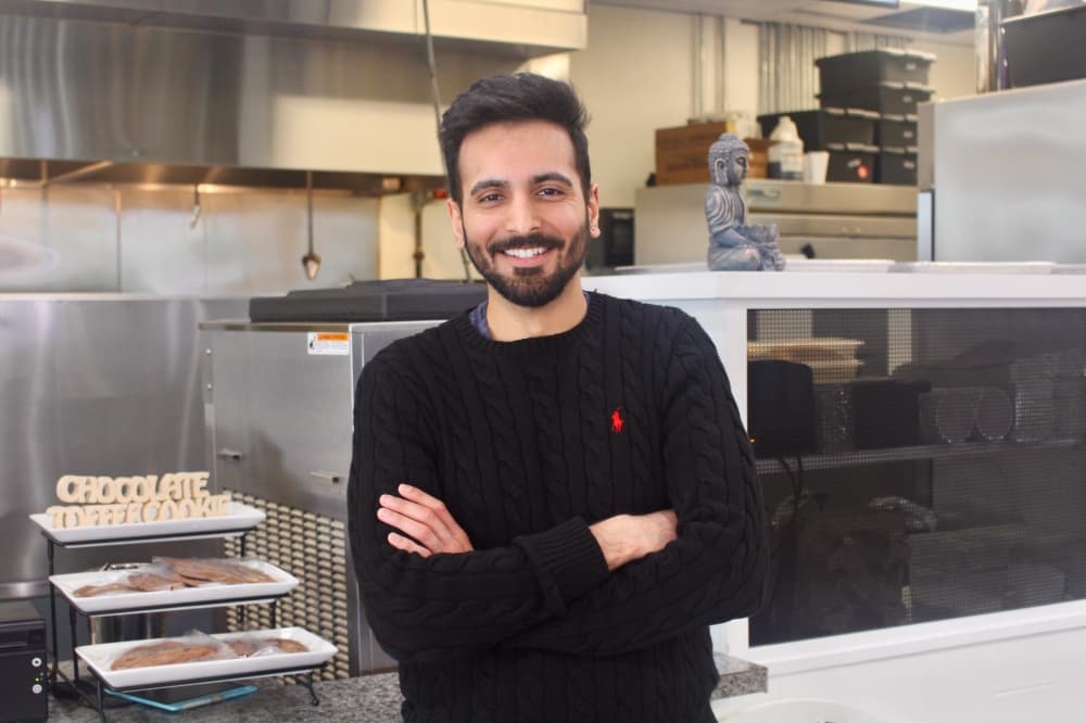 owner stands in a kitchen area