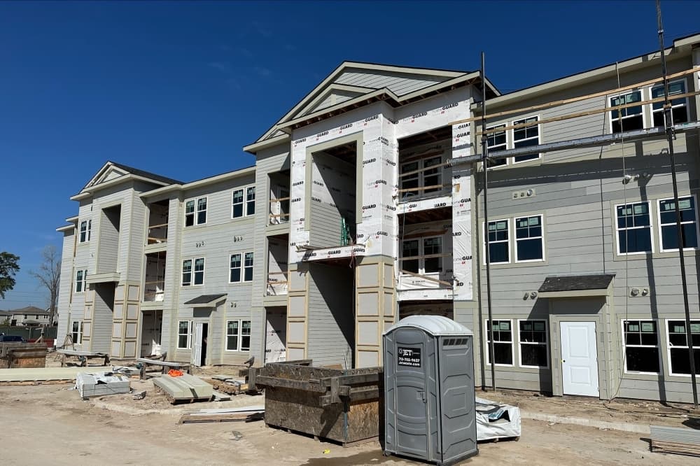 The photo shows the exterior of the Lively at Cypress Creek apartments.